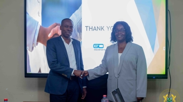 Commissioner Angela C. Bush and Mr. Wisdom Donkor shaking hands