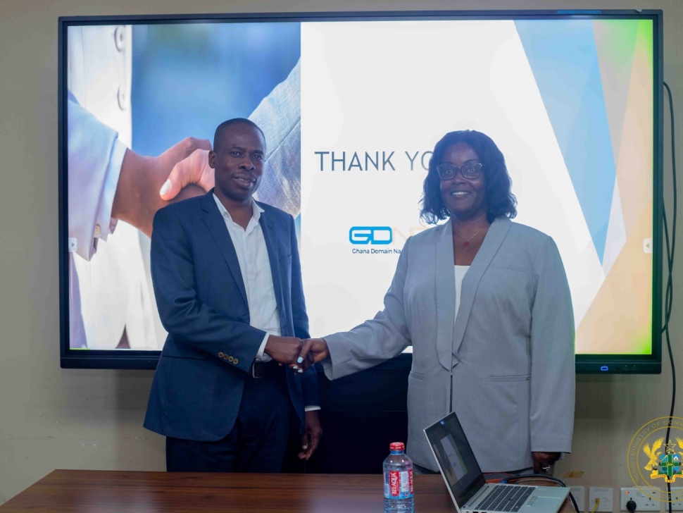 Commissioner Angela C. Bush and Mr. Wisdom Donkor shaking hands