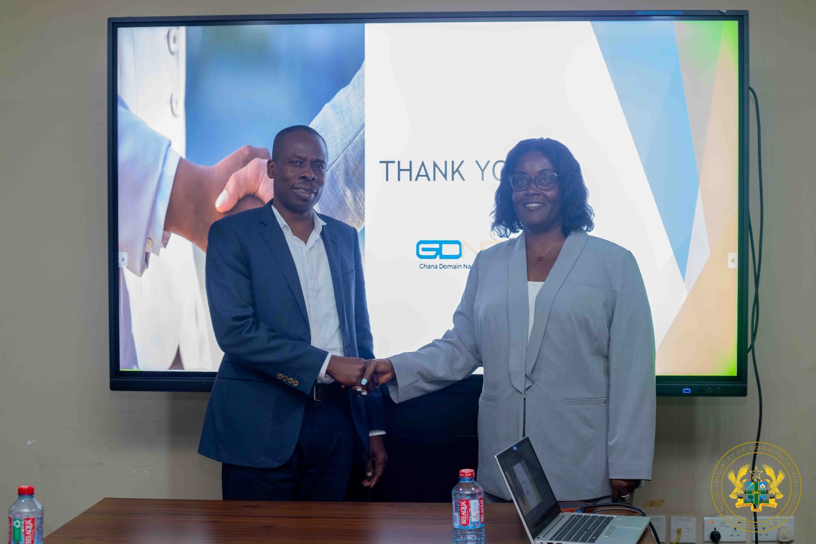 Commissioner Angela C. Bush and Mr. Wisdom Donkor shaking hands
